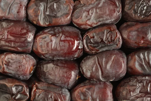 Dried dates arranged in rows. View from above. Food background