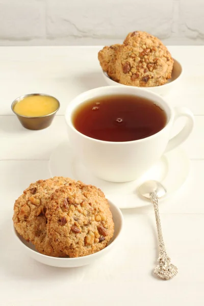Oatmeal Cookies Walnuts Raisins Small Saucers Cup Black Tea Standing — Stock Photo, Image