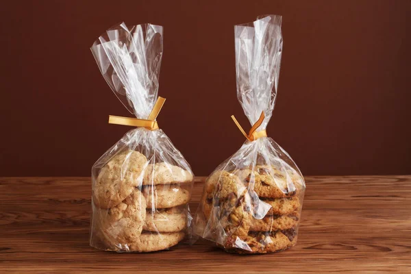 Oatmeal Cookies Walnuts Raisins Almond Cookies Transparent Bags Wooden Table — Stock Photo, Image