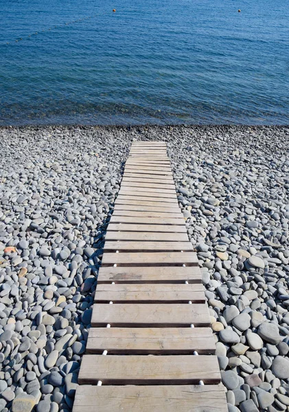Wooden path to the sea. Flooring of planks on the path to the sea.