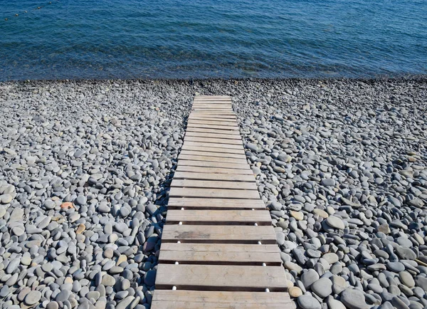 Wooden path to the sea. Flooring of planks on the path to the sea.