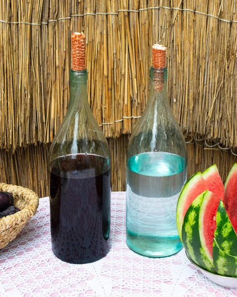 Garrafas Vinho Luar Mesa Uma Cesta Com Uma Ameixa Uma — Fotografia de Stock