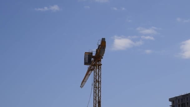 Torre de construcción de grúa contra el cielo azul y el sol. Construcción de nuevos edificios con grúa. Grúa torre . — Vídeos de Stock