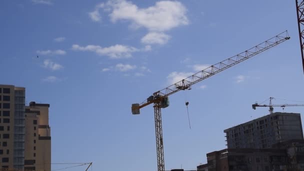 Tower building crane against the blue sky and sun. Construction of new buildings with a crane. Tower crane. — Stock Video