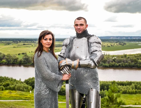Knight with his lady in armor and chain mail.