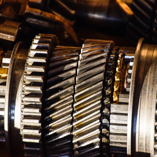 Dismantled box car transmissions. The gears on the shaft of a mechanical transmission.