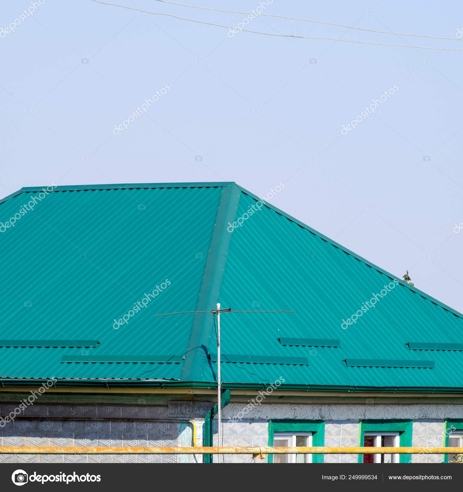 Green metal profile corrugated roofing on the house. ⬇ Stock Photo