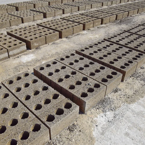 Cinder blocks lie on the ground and dried. on cinder block production plant.
