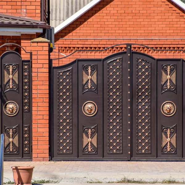 Gates of brown metal sheets. Roofing materials. — Stock Photo, Image
