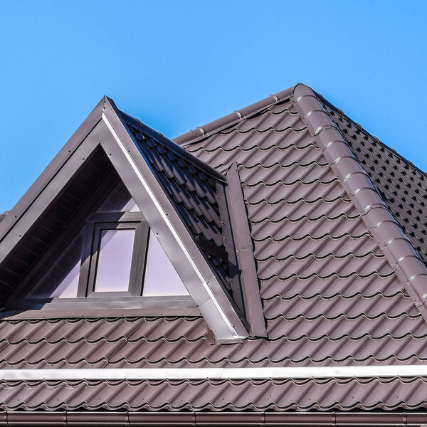 House with plastic windows and a brown roof of corrugated sheet