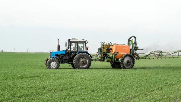 Traktor dengan perangkat semprot untuk pupuk halus yang tersebar . — Stok Foto