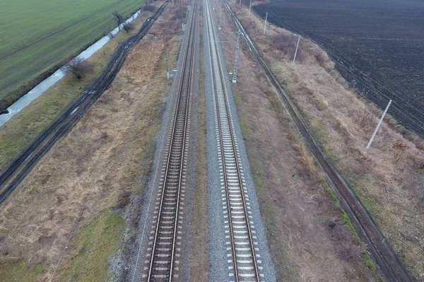 Plot railway. Top view on the rails. High-voltage power lines fo