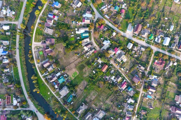 Blick von oben auf das Dorf. Man sieht die Dächer der Häuser und Gärten. Straße und Wasser im Dorf. Dorfperspektive — Stockfoto