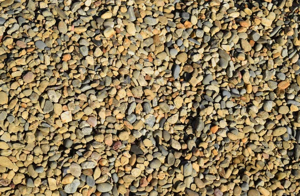 Fondo de pequeña piedra redonda triturada — Foto de Stock