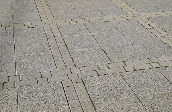Выясните тротуарные плиты на площади. Фон тротуарной плиты. Текстура изделий из камня — стоковое фото