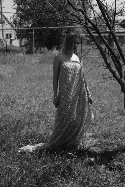 Foto en blanco y negro, chica en el jardín en un prado en un vestido . — Foto de Stock