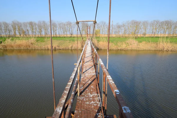 Steel bridge and gas pipeline through irrigation canal. — Stock Photo, Image