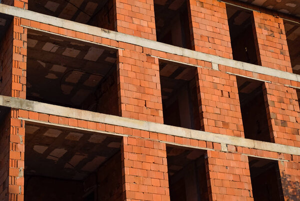 Construction of a new house of bricks. High-rise construction.