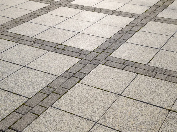 Figure out the paving slabs in the square. Background of paving slabs. Texture of stone products