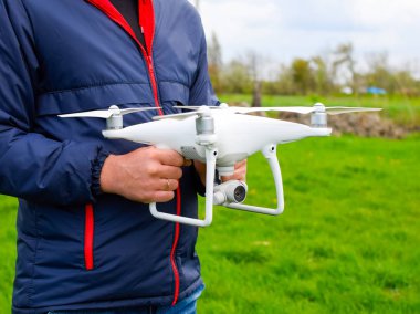 Quadrocopter onun elinde olan bir adam. Beyaz bir drone uçuş için hazırlanıyor. Hayalet.