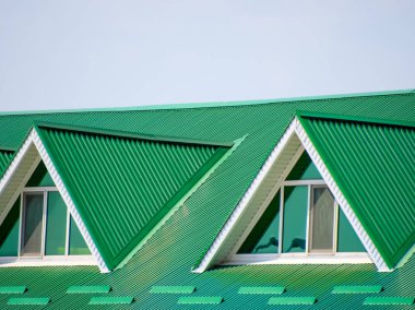 Plastik pencere ve oluklu levha yeşil bir çatı olan ev. Yeşil çatı oluklu metal profil ve plastik pencere.