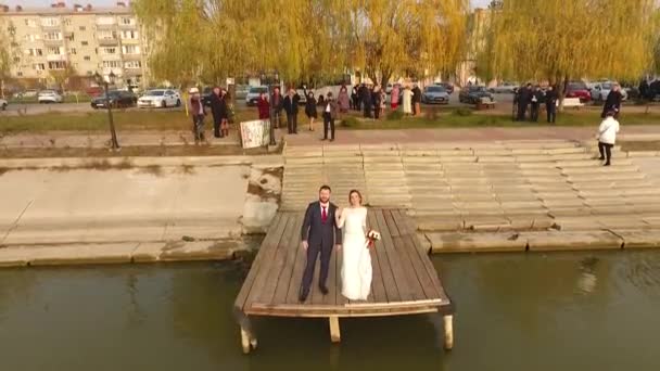 Nowożeńcy ślubu w prowincjonalnym miasteczku, strzał z dronem. — Wideo stockowe