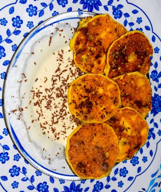 Tabakta ekşi krema ve çikolata parçacıkları ile Cheesecakes.