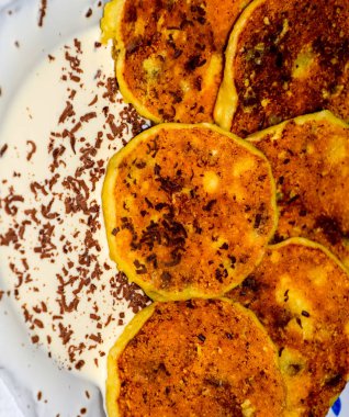 Tabakta ekşi krema ve çikolata parçacıkları ile Cheesecakes.