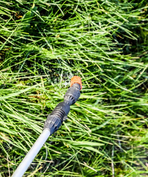 Spraying herbicide from the nozzle of the sprayer manual — Stock Photo, Image