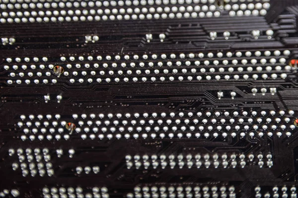 The reverse side of the microboard. Contacts solder. Soldered parts. Electronic board with electrical components. Electronics of computer equipment — Stock Photo, Image