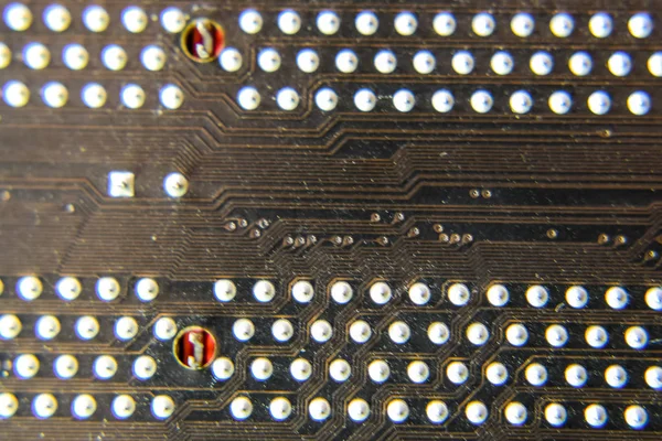 The reverse side of the microboard. Contacts solder. Soldered parts. Electronic board with electrical components. Electronics of computer equipment