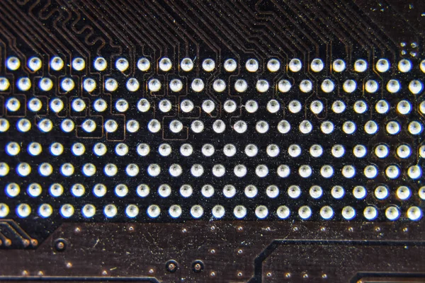 The reverse side of the microboard. Contacts solder. Soldered parts. Electronic board with electrical components. Electronics of computer equipment