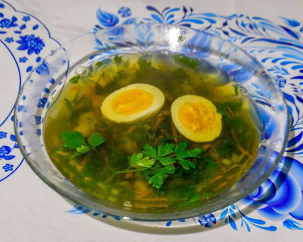 Soup with boiled egg and parsley