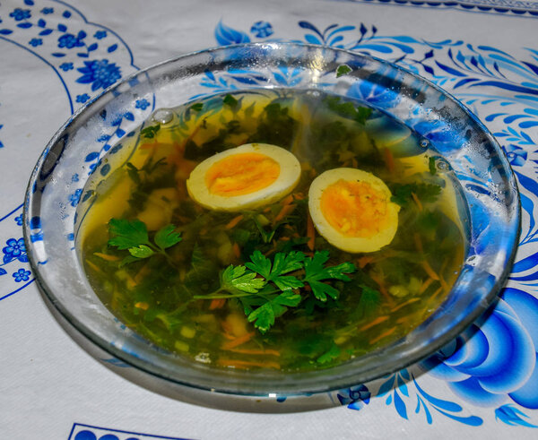 Soup with boiled egg and parsley