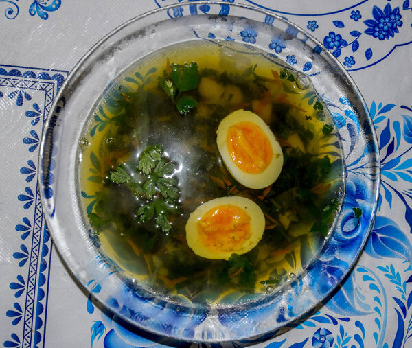 Soup with boiled egg and parsley