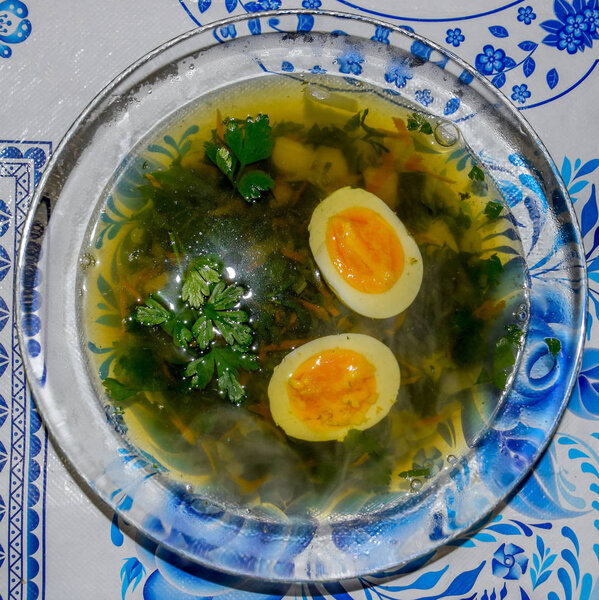 Soup with boiled egg and parsley