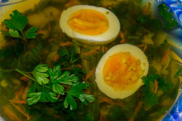 Soup with boiled egg and parsley