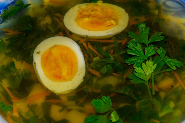 Soup with boiled egg and parsley
