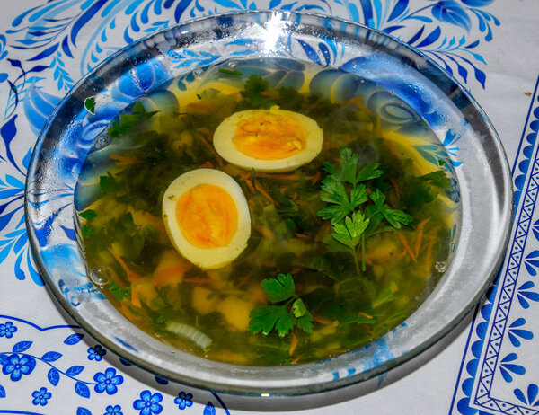 Soup with boiled egg and parsley