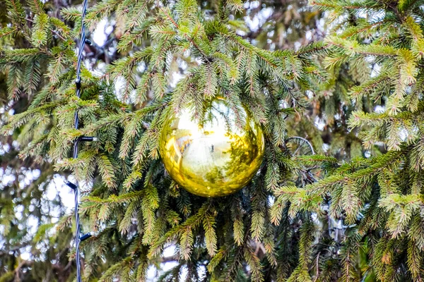 Decorazioni albero di Capodanno. Tagliatelle e giocattoli, palline e altre decorazioni sull'albero di Natale in piedi all'aria aperta . — Foto Stock