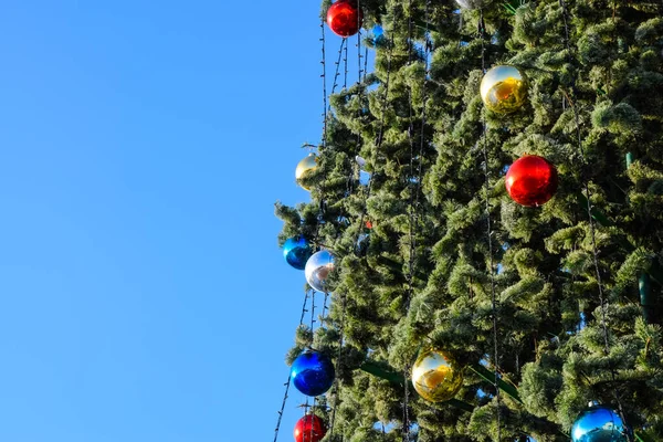 Drzewo Nowy Rok dekoracji. Blichtr i zabawki, kulki i inne dekoracje na Boże Narodzenie Boże Narodzenie drzewo stojące na wolnym powietrzu. — Zdjęcie stockowe