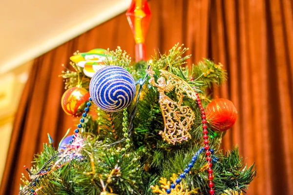 Decorações árvore de Ano Novo. Tinsel e brinquedos, bolas e outras decorações na árvore de Natal de pé ao ar livre . — Fotografia de Stock