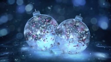 İki dönen Noel mavi buz Baubles renkli yaprakları arka plan döngü kar