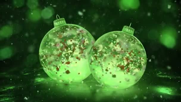 Deux boules de glace vertes de Noël rotatives neige pétales colorés fond boucle — Video