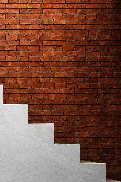 Light and shadow of red brick wall and white concrete stairway.