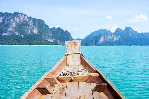 Wooden boat in lake with defocused limestone mountains background