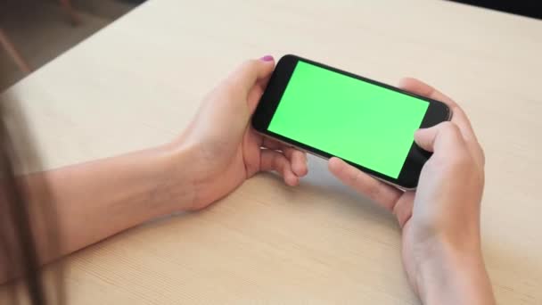 Gadis cantik memegang smartphone di tangan layar hijau layar hijau hijau layar hijau, tangan manusia memegang ponsel pintar dengan kunci kroma layar hijau pada latar belakang putih, konsep teknologi baru — Stok Video