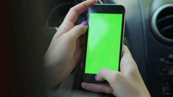 Girl Driver closeup, greenscreen in the car, urban city background greenscreen chrome key 4k. Sweeps his hand across the screen to the up. — Stock Video