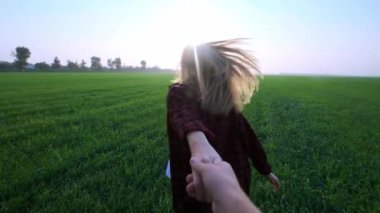 Beni, günbatımı, ağır çekim Genç yeşil buğday tarlası ile kaçan genç mutlu kız izle, flare lens