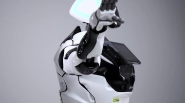 Modern Robotik teknolojiler. Beyaz modern robot parlak bir stüdyoda. Bir tebrik el sallayarak android görüntüleyiciyi selamlıyor. Beyaz zemin üzerinde bir robot gösteri. Burada gelecek.